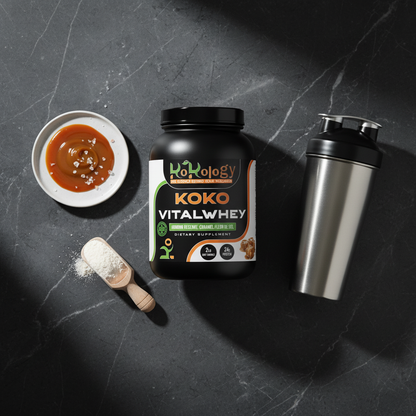 Koko VitalWhey Armour Reserve Caramel Fleur de Sel flat lay with caramel drizzle, fleur de sel crystals and steel shaker on dark marble